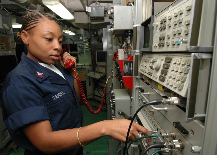 US Navy 061023-N-6403R-012 Information Systems Technician 2nd Class Hendra Samuel from Wayne, N.J., checks for a shipboard to shipboard circuit in the joint message center (JMC) shop aboard USS Iwo Jima (LHD 7)