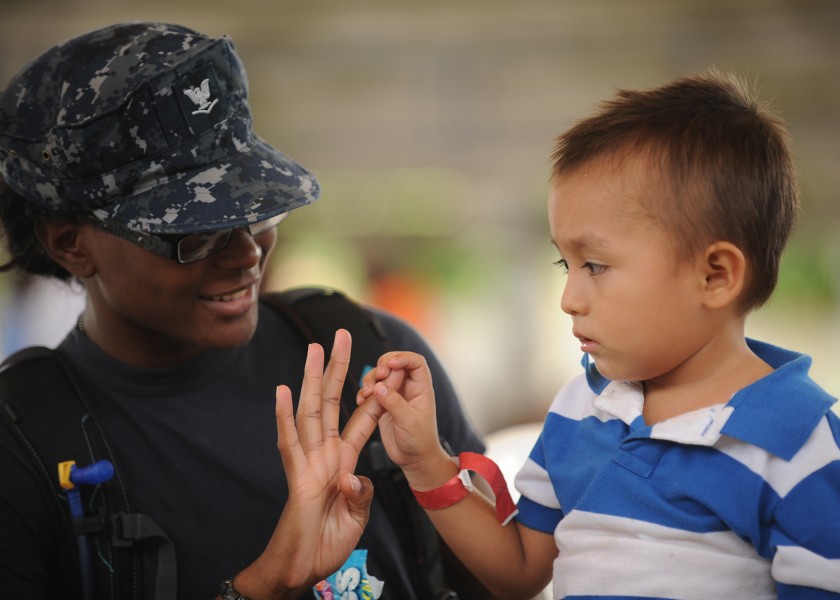 US Navy 110715-N-NY820-340 Hospital Corpsman 3rd Class Chavone Taylor plays with a pediatrics patient during a Continuing Promise 2011 community se