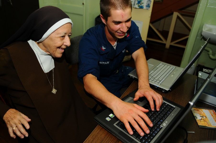 US Navy Information Systems Technician teaches Carmelite Sister to use the Internet