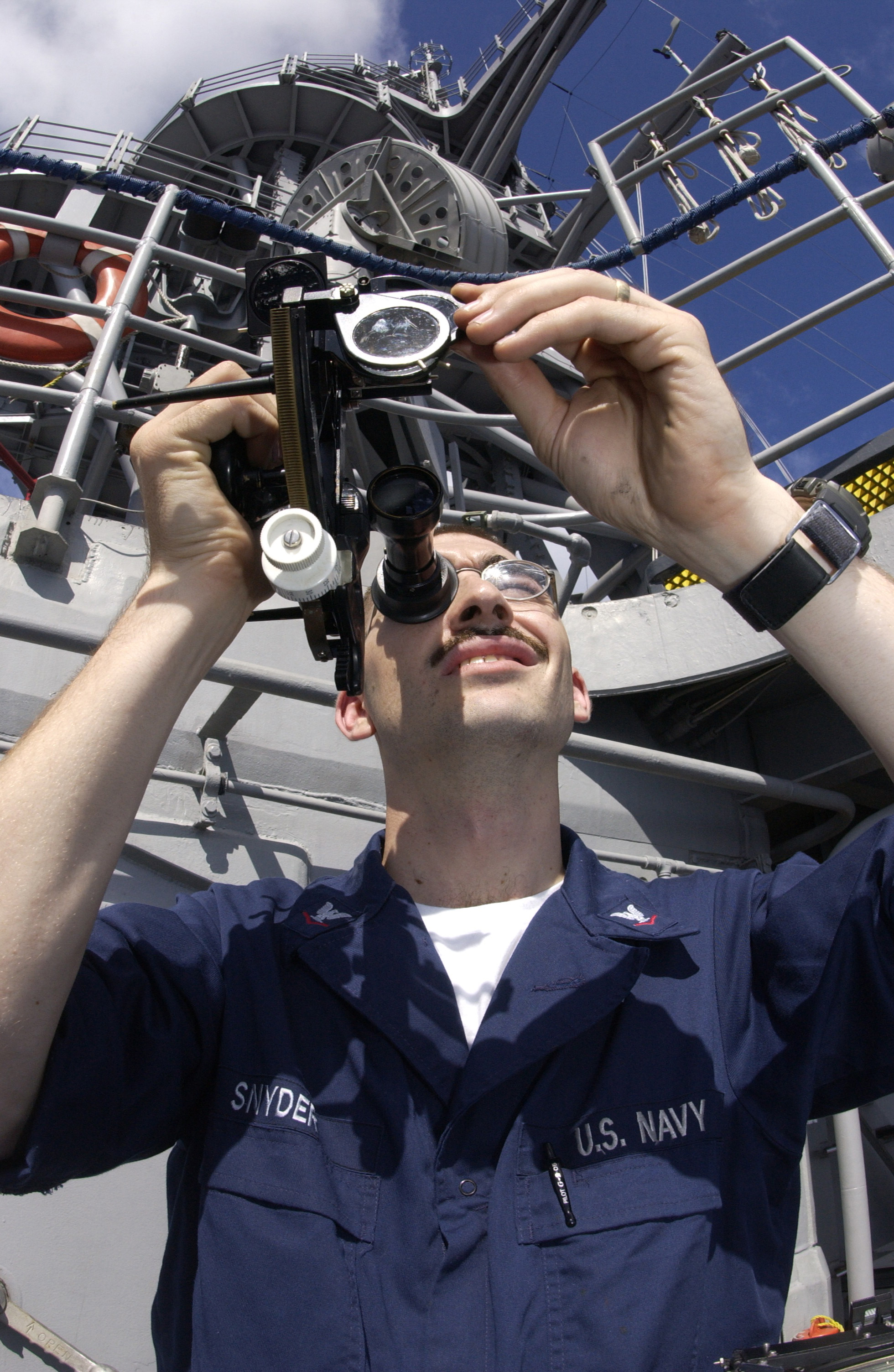 US Navy 030822-N-2613R-001 Aboard the destroyer USS Cushing (DD 85), Quartermaster 3rd Class Ryan Snyder, from Metropolis, Ind. shoots an azimuth bearing using a sextant