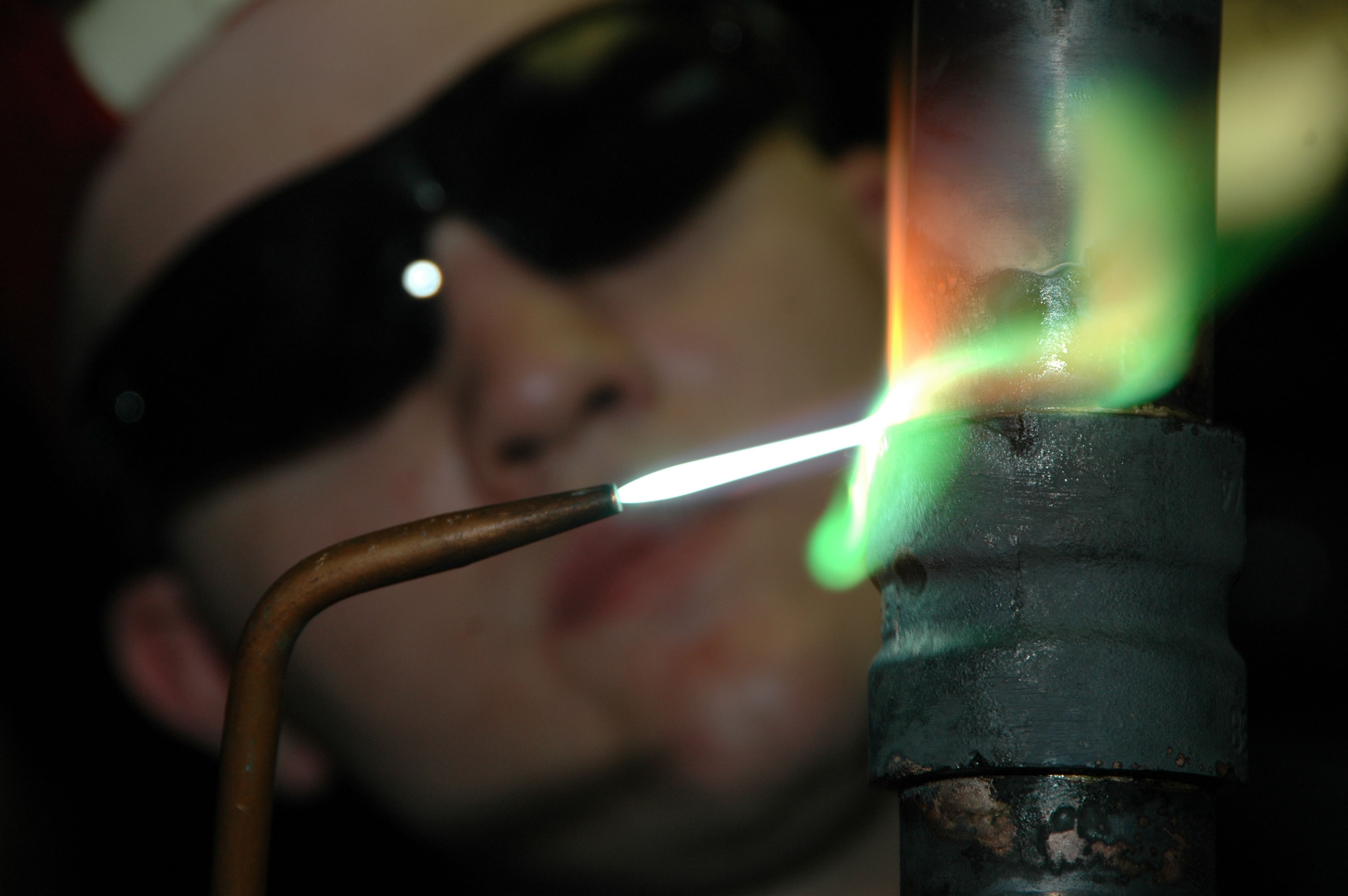 US Navy 060528-N-1332Y-022 Hull Maintenance Technician Fireman Bob Chambers uses a brazing torch to weld a one-and-a-half-inch copper-nickel pipe in the pipe shop aboard USS Kitty Hawk (CV 63)
