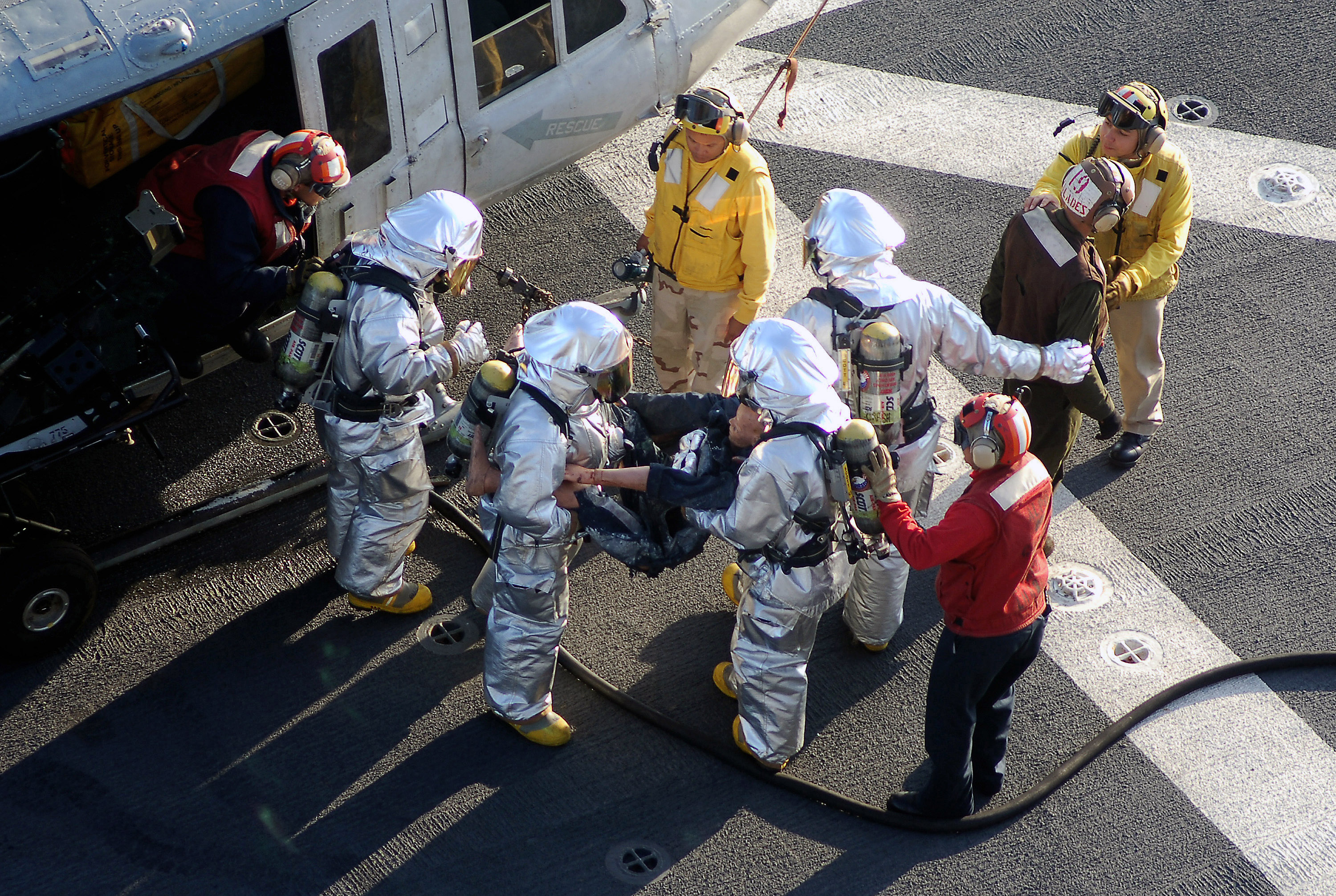 US Navy 070918-N-4774B-159 The crash and salvage team aboard amphibious assault ship USS Tarawa (LHA 1) trains for handling an emergency helicopter landing and rescue of wounded personnel