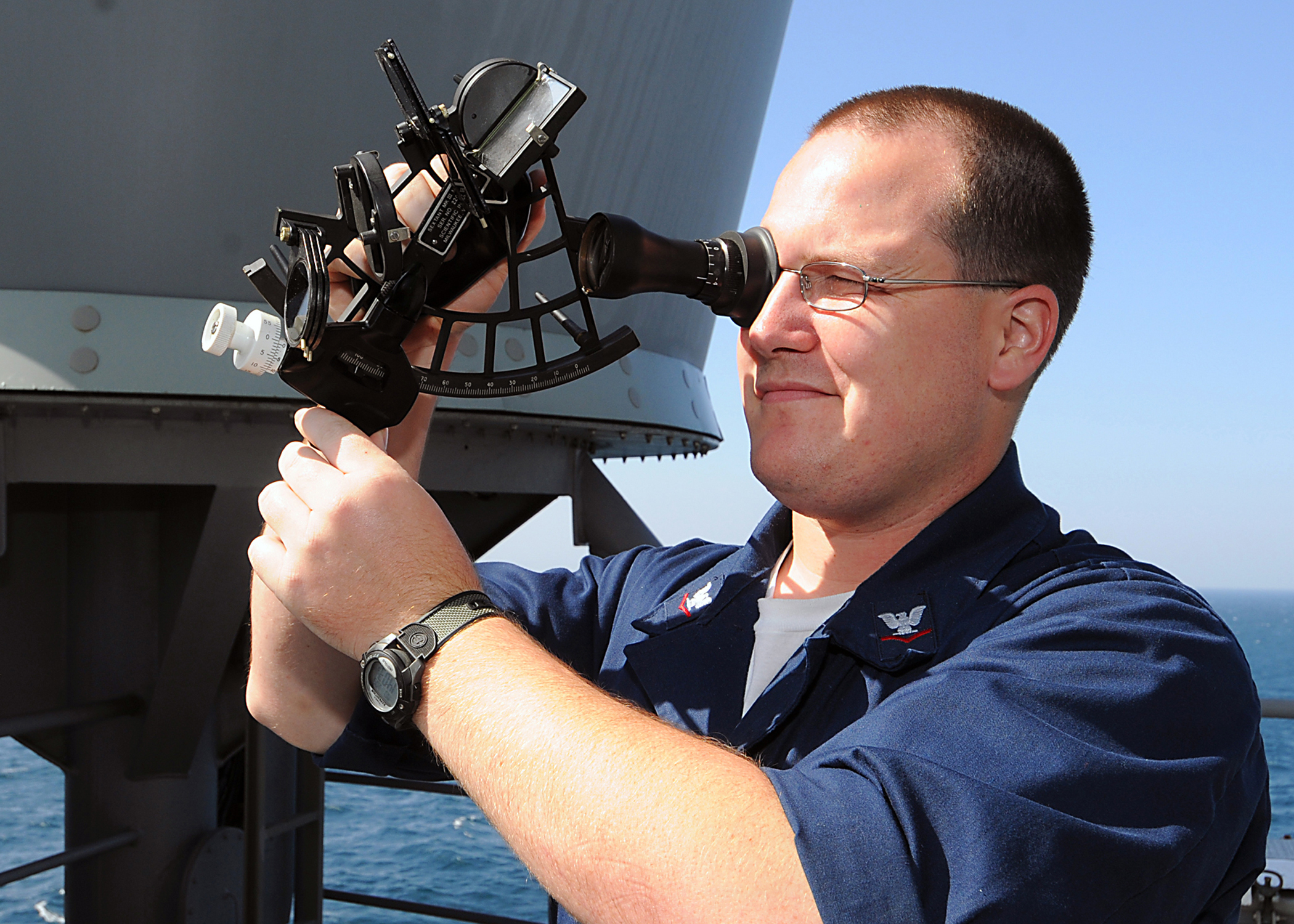 US Navy 090105-N-1082Z-015 Quartermaster 3rd Class Matthew A. James uses a sextant aboard the guided-missile cruiser USS Vella Gulf (CG 72)