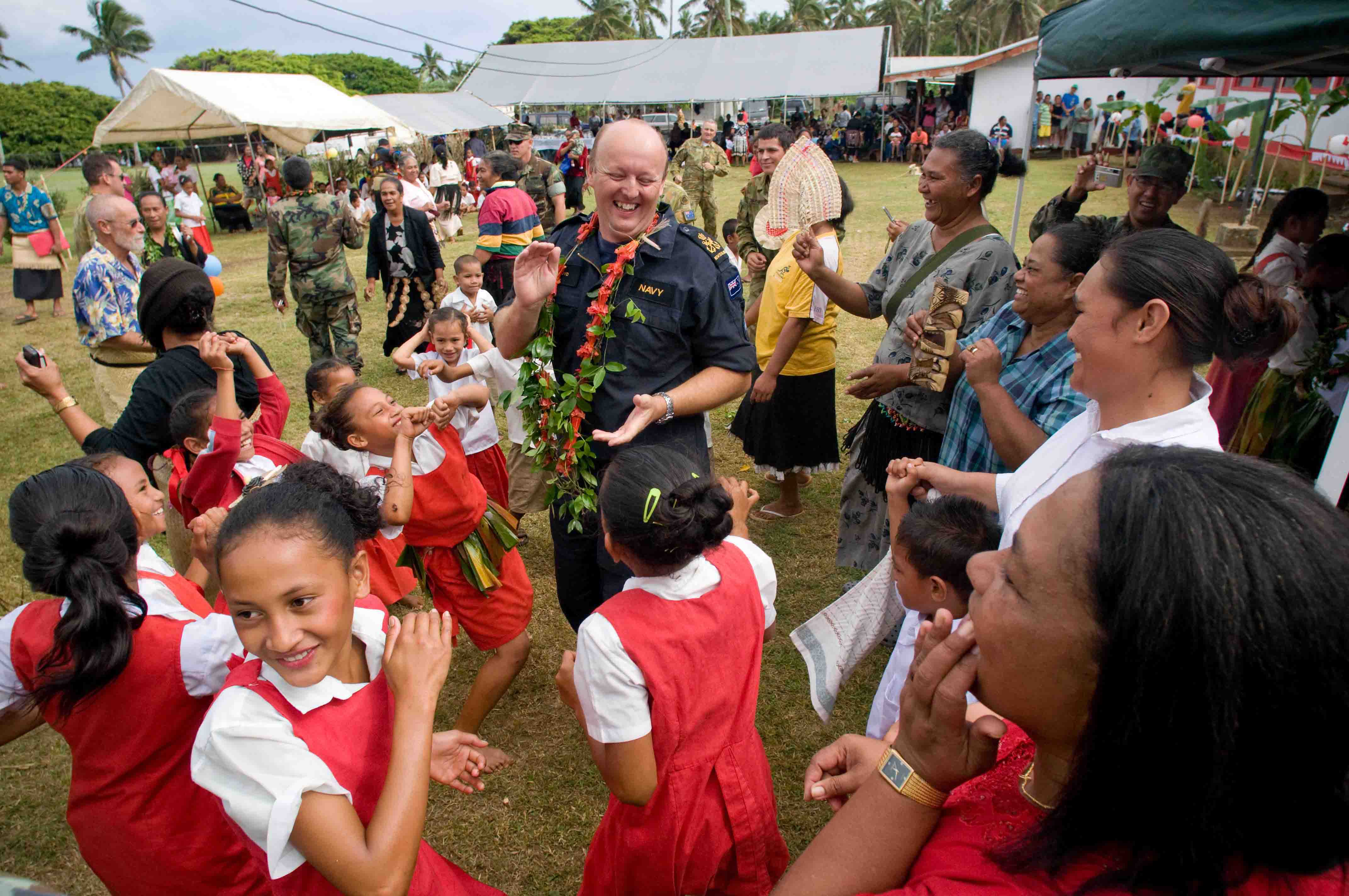 US Navy 090724-N-9689V-004 Royal New Zealand Navy Petty Officer Richard Boyd dances with school children during a Pacific Partnership 2009 community service project at Faleloa Primary School