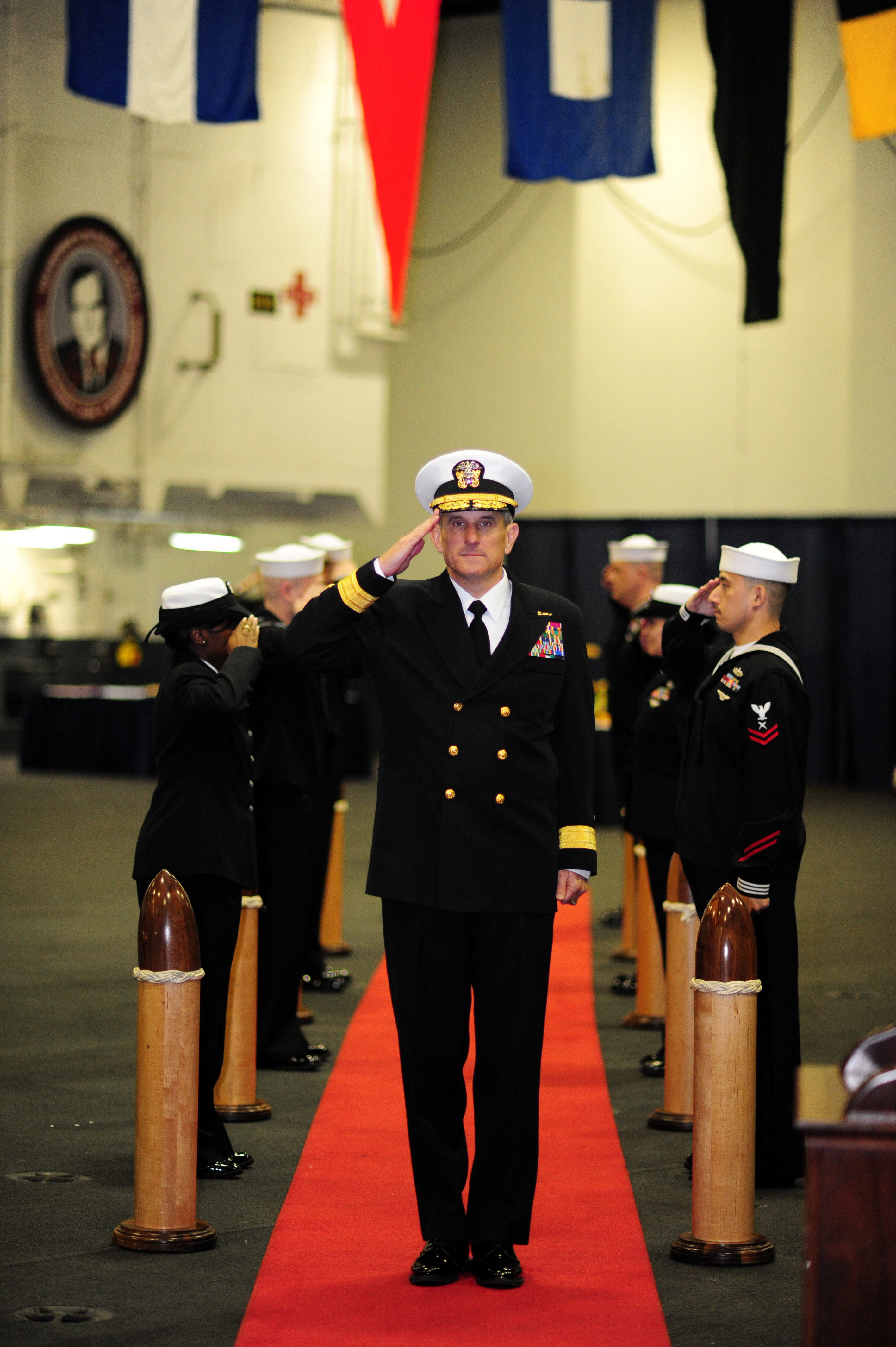 US Navy 120112-N-PW494-078 Rear Adm. Gregory M. Nosal passes through ceremonial sideboys during a change of command ceremony in which he relieved R