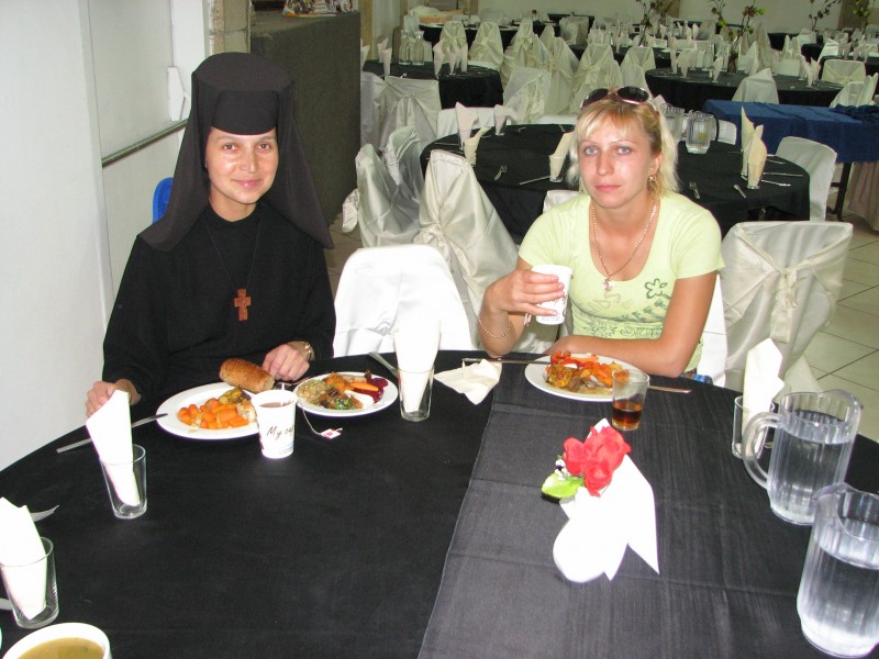 A Catholic nun and a girl in a hotel's restaurant in Israel - catholic pilgrims.