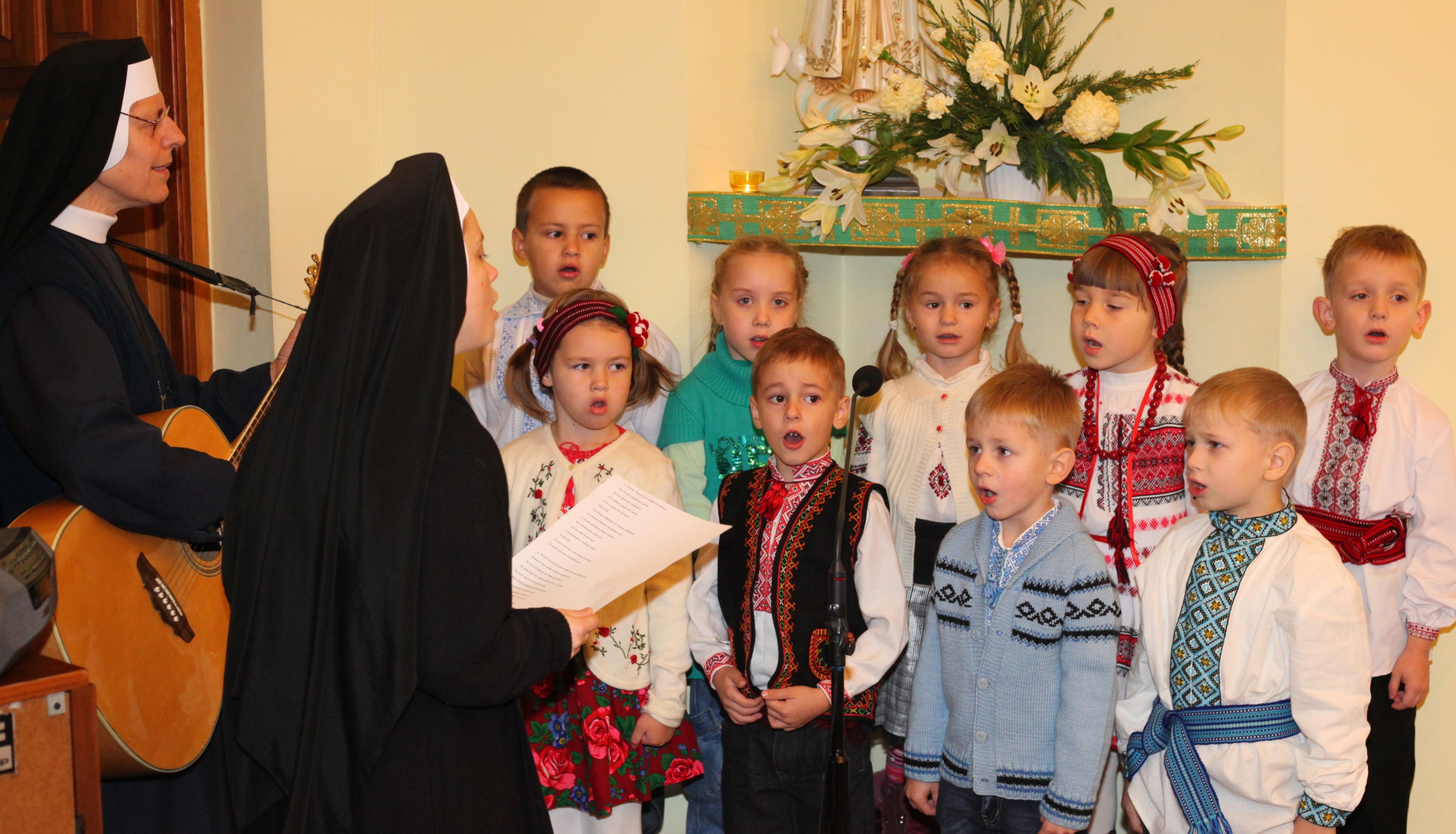 children singing with nuns in a Catholic kindergarten