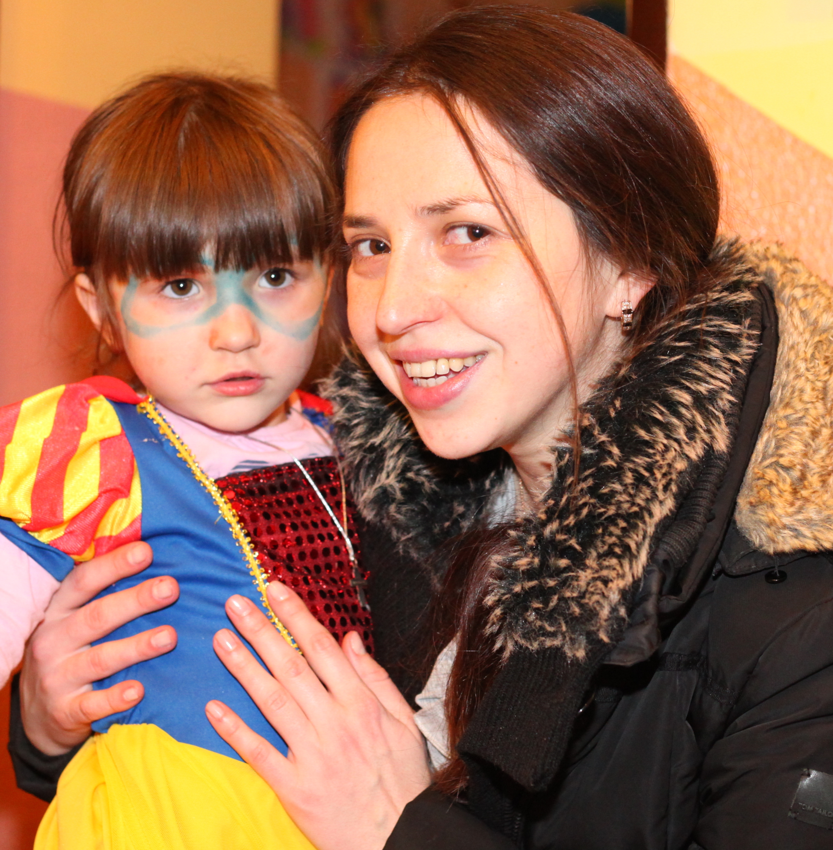 a beautiful brunette Catholic woman with her cute daughter in a Catholic kindergarten, photo 1