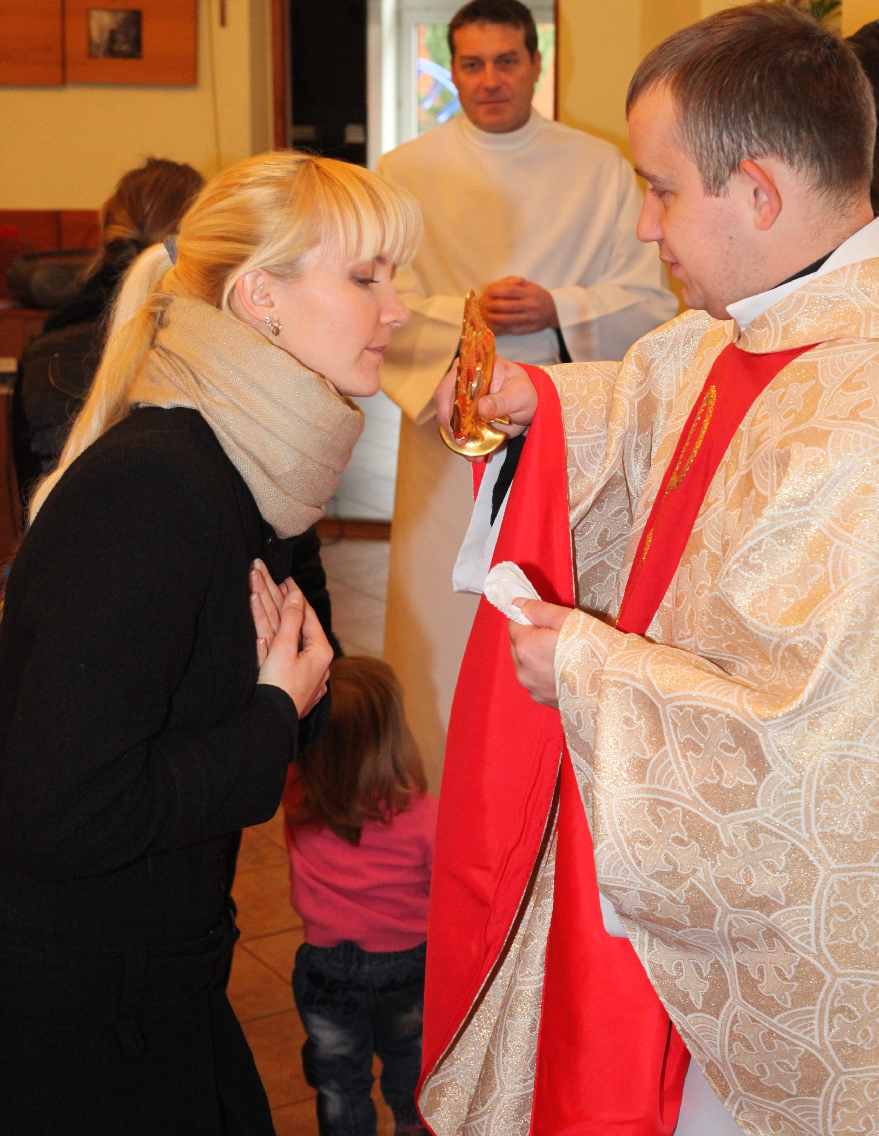 an amazingly tender and charming beautiful young blond Catholic woman in a Church kissing relics of a saint, photo 23