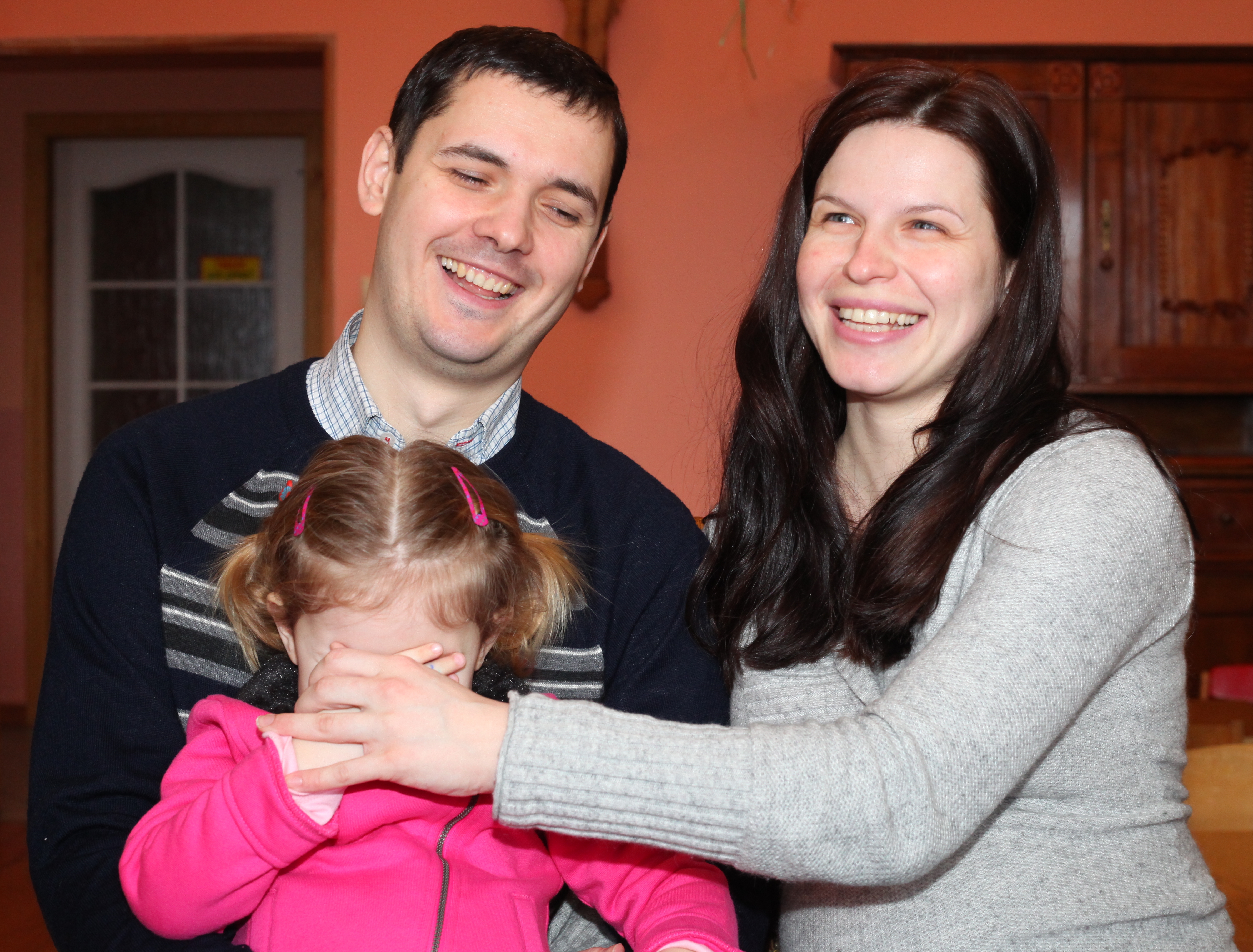 a pregnant beautiful brunette Catholic woman with her husband and daughter, picture 13