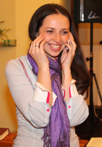 an amazingly attractive smiling charming beautiful young brunette Catholic woman talking over a mobile phone, photo 2