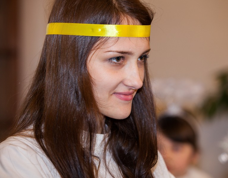 a young brunette Catholic woman in a church photographed in December 2013, picture 9