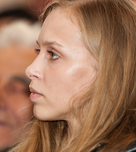 a young fair-haired woman photographed in a Catholic church in May 2014, portrait 2/4