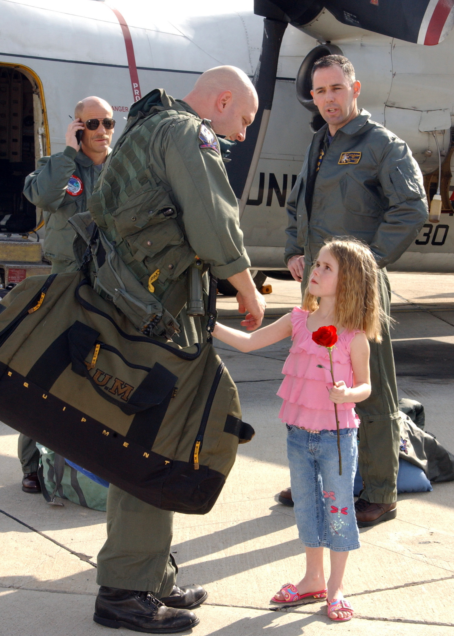 US Navy 050228-N-7615S-019 Lt. Cmdr. Chris Marlar reunites with his daughter after returning home to San Diego, Calif., from deployment
