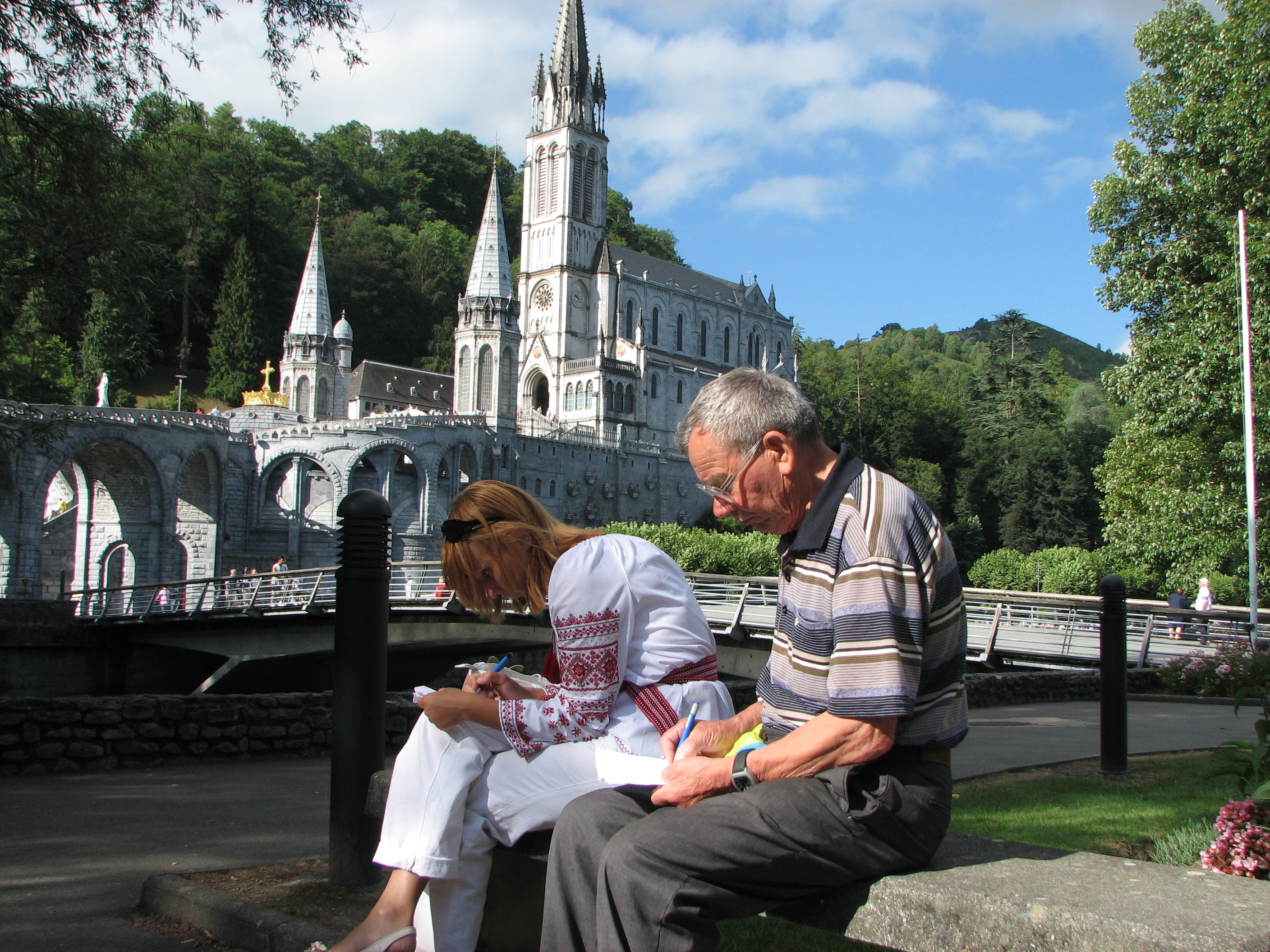 A young woman and an old man in Lourdes, France, 2010.