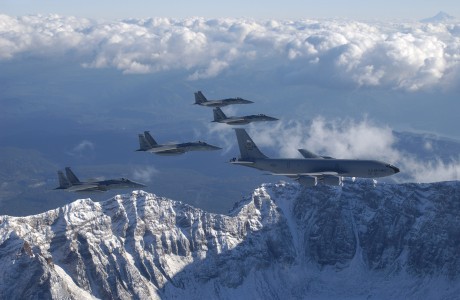 A KC-135 Stratotanker from the 939th Air Refueling Squadron, and four F-15 Eagles from the 123rd Fighter Squadron, fly over the Northwest Cascade Mountains during a mission. Both units are assigned to the 142nd Fighter Wing located at Portland International Airport, Portland, Oregon, Oregon Air National Guard, Nov 3, 2003. (U.S. Air Force Photo/Tech. Sgt. Michael Ammons)