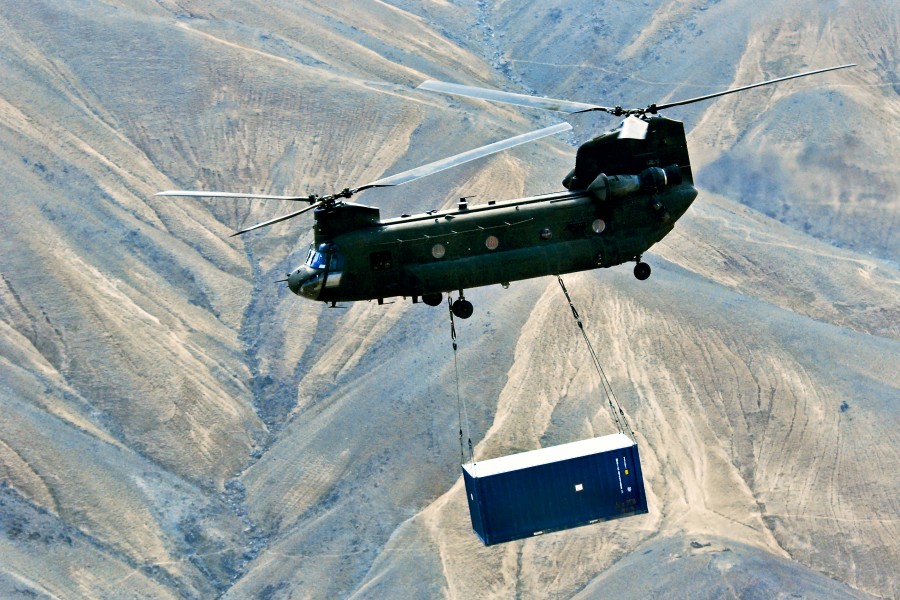 A U.S. Army CH-47 Chinook helicopter carries a sling-loaded shipping container during retrograde operations and base closures in the Wardak province of Afghanistan 131026-A-SM524-737