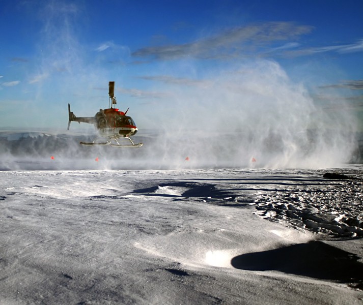 Helicopter is taking off Greenland ice sheet 