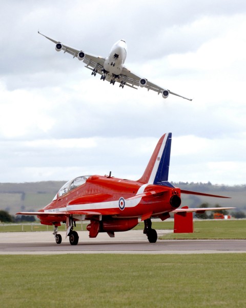 On Boeing 747 Swoops Over a Royal Air Force Red Arrow at Air Show MOD 45145189