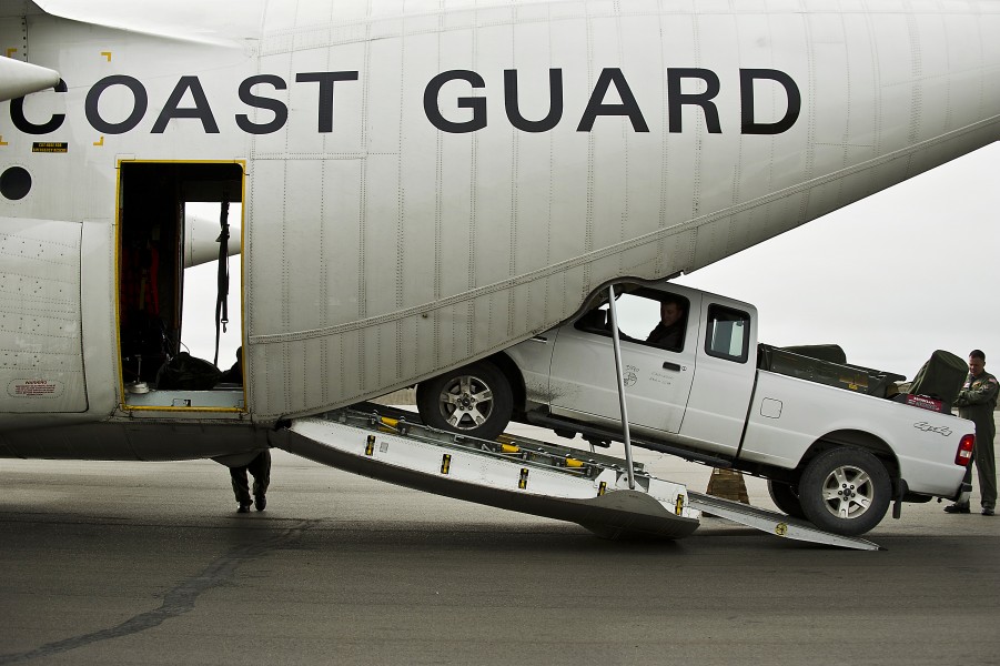U.S. Coast Guardsmen unload a vehicle from an HC-130H Hercules aircraft in Barrow, Alaska, June 28, 2012 120628-F-MQ656-064