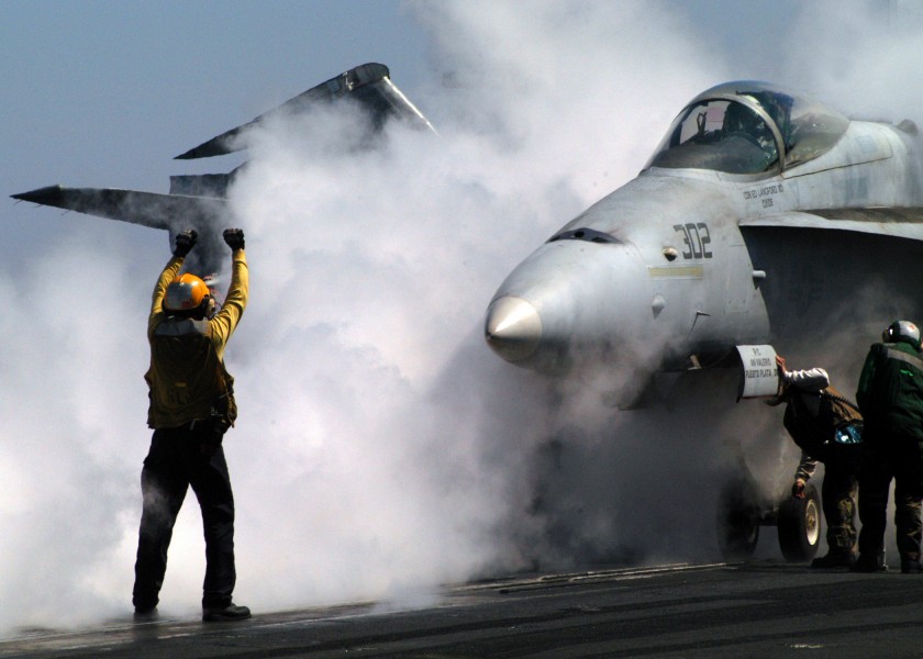 US Navy 030503-N-2410G-509 An Aviation Boatswain's Mate Handler directs an F-A-18 Hornet from the Valions of Strike Fighter Squadron One Five (VFA-15)
