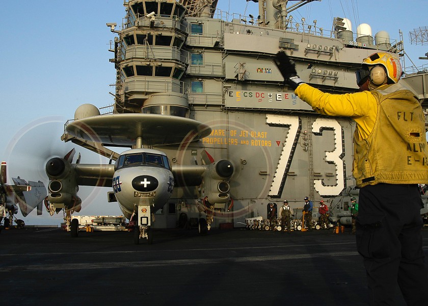 US Navy 040529-N-9630B-025 Aviation Boatswain's Mate 1st Class Floyd Harvell, of Cleveland, Ohio, directs an E-2C Hawkeye assigned to the Bluetails of Carrier Airborne Early Warning Squadron One Two One (VAW-121)