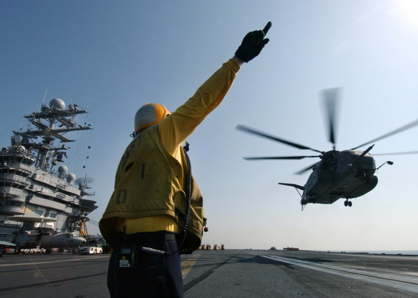 US Navy 041120-N-5345W-152 Aviation Boatswain's Mate 2nd Class Christopher Carter, give hand signals to the crew of an MH-53E Sea Dragon assigned to the Blackhawks, of Helicopter Mine-Countermeasure Squadron One Five (HM-15)