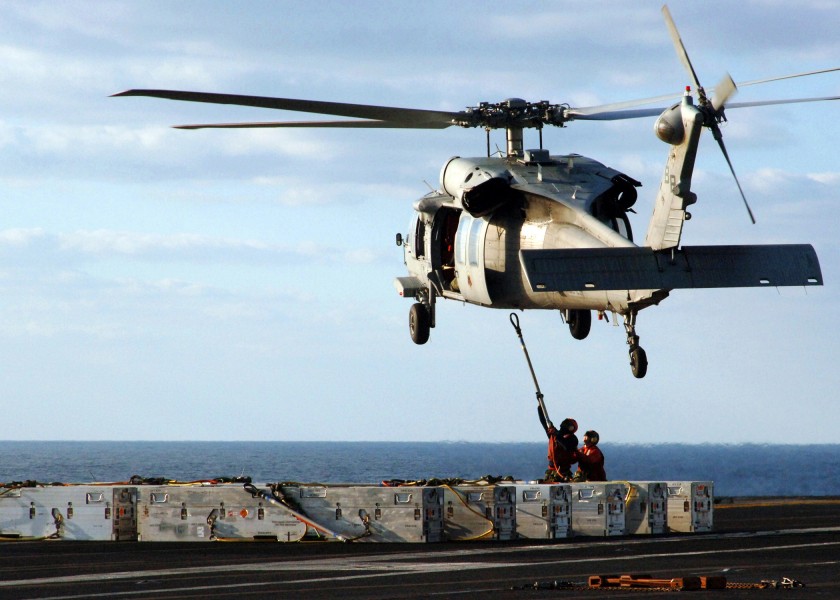 US Navy 051103-N-6125G-071 Aviation Ordnancemen attach ordnance to an MH-60S Seahawk helicopter