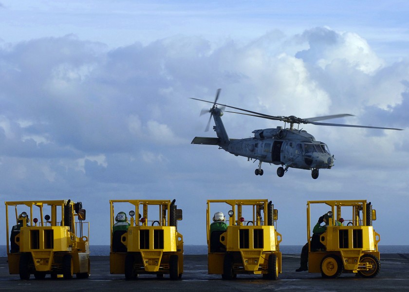 US Navy 051115-N-9742R-003 Supply Department personnel standby in forklifts to move pallets of food and cargo