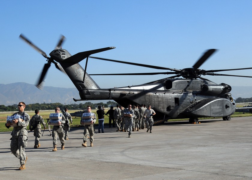 US Navy 100115-N-6247V-419 U.S. Army soldiers unload food and supplies from a U.S. Navy MH-53E Sea Dragon helicopter from the aircraft carrier USS Carl Vinson (CVN 70) at the airport in Port-au-Prince, Haiti