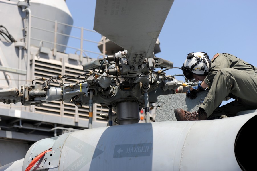 US Navy 100512-N-0553R-036 Sailor checks helicopter before flight aboard USS San Jacinto