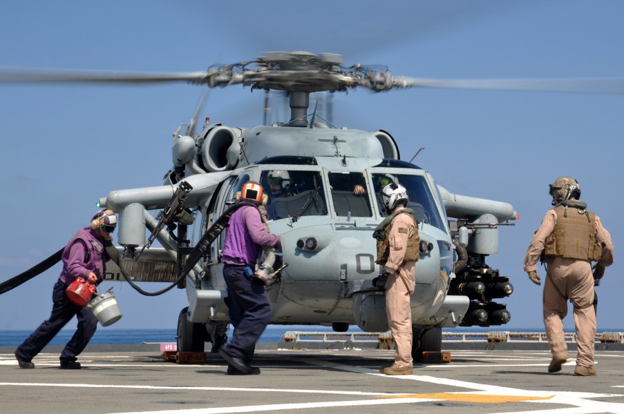 US Navy 110325-N-7293M-126 Sailors run to refuel an MH-60S Sea Hawk helicopter