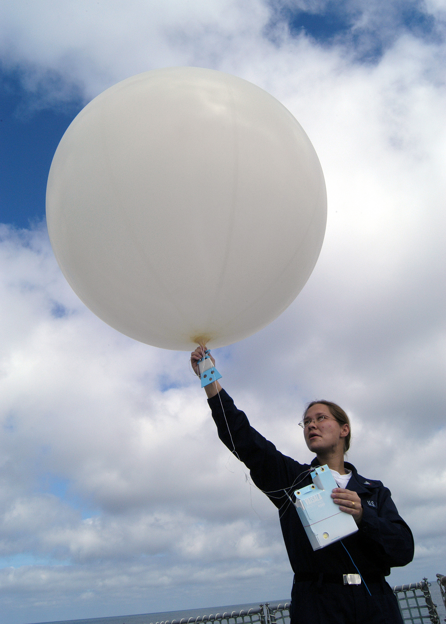 US Navy 030222-N-8029P-001 Aerographer's Mate 3rd Class Mandy Fetterman launches a 100-gram weather balloon 
