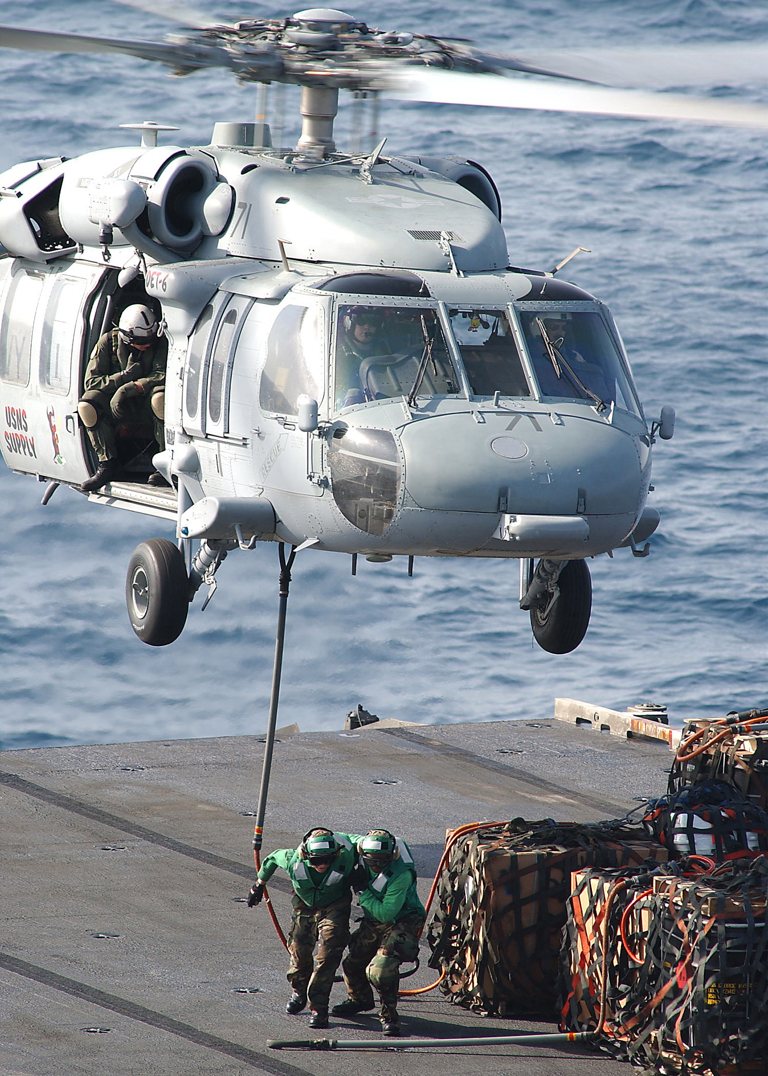 US Navy 040623-N-1082Z-002 An MH-60S Knighthawk assigned to the Chargers of Helicopter Combat Support Squadron Six (HC-6), Detachment 6, transports supplies to USS George Washington (CVN 73)