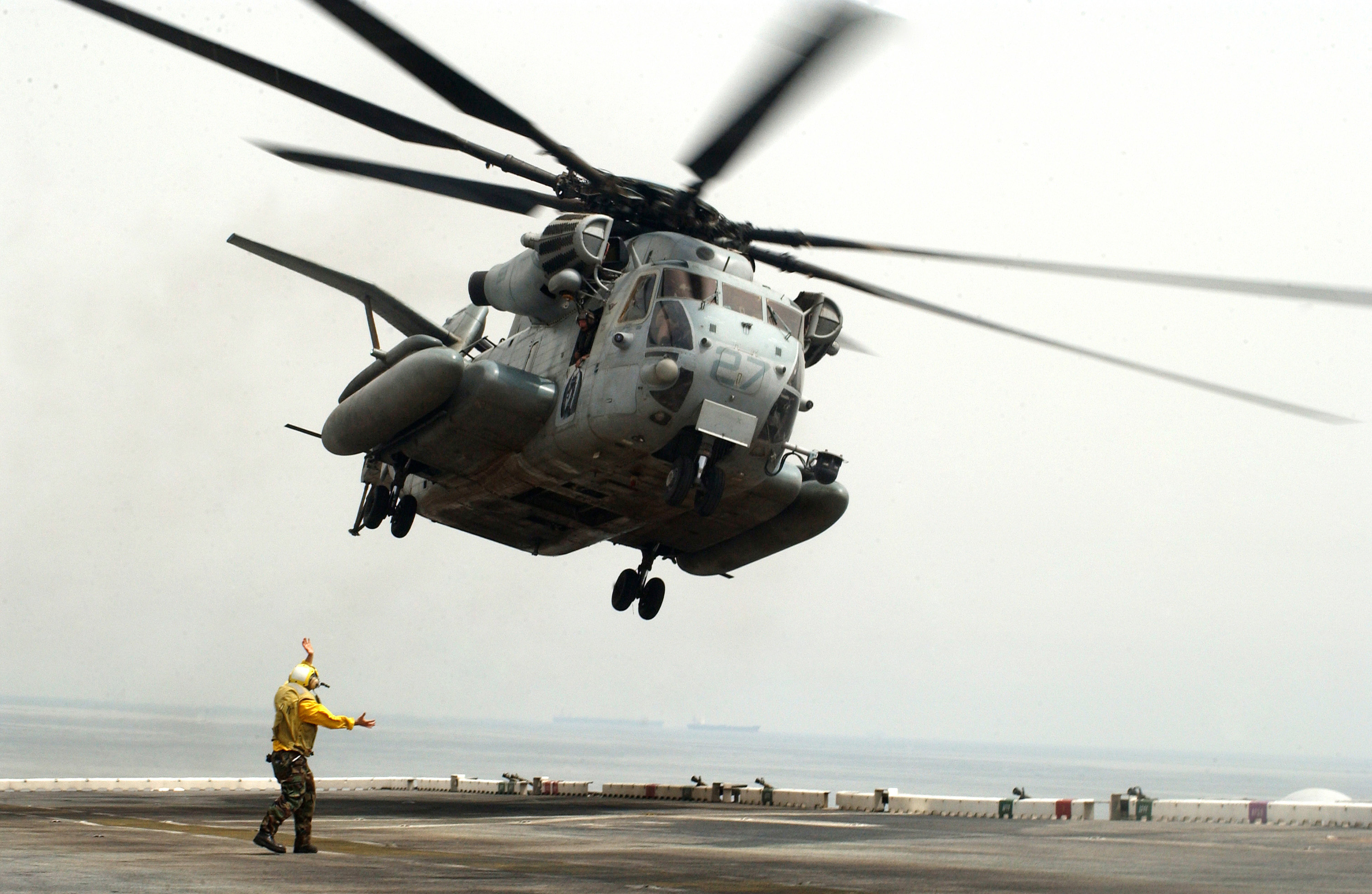 US Navy 060430-N-9866B-042 A CH-53 Super Stallion helicopter takes off from the flight deck aboard the amphibious assault ship USS Peleliu (LHA 5)