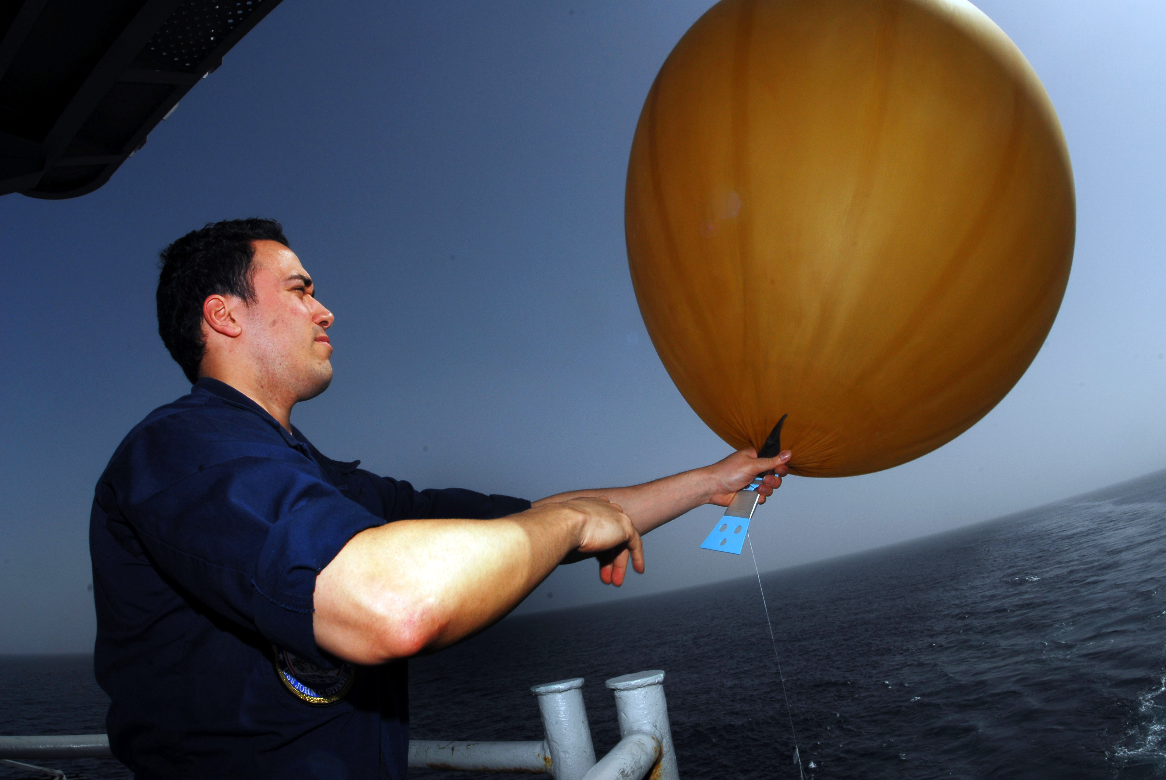 US Navy 070305-N-9928E-076 Airman Jaime Minor inflates a weather balloon on the fantail aboard Nimitz-class aircraft carrier USS John C. Stennis (CVN 74)