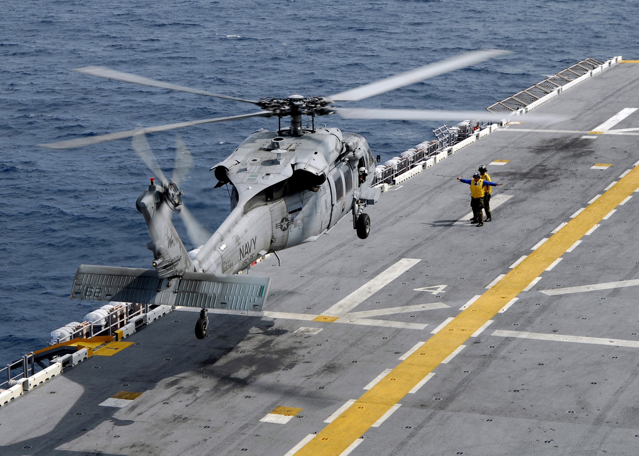 US Navy 080828-N-4236E-589 An MH-60S Sea Hawk helicopter lands on the flight deck of the multi-purpose amphibious assault ship USS Iwo Jima (LHD 7)