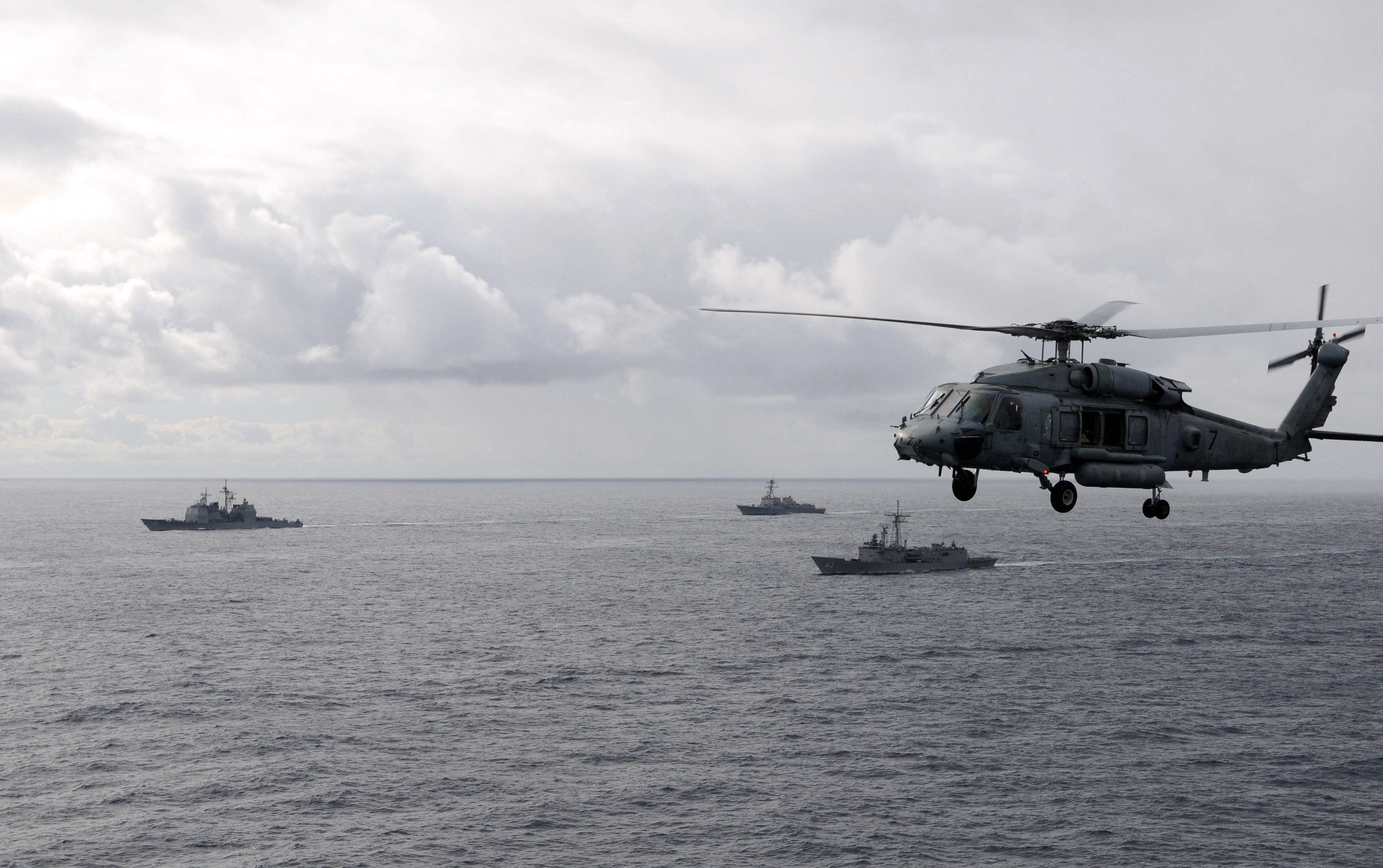 US Navy 081121-N-3659B-127 An HH-60H Sea Hawk flies past ships preparing for an air power demonstration