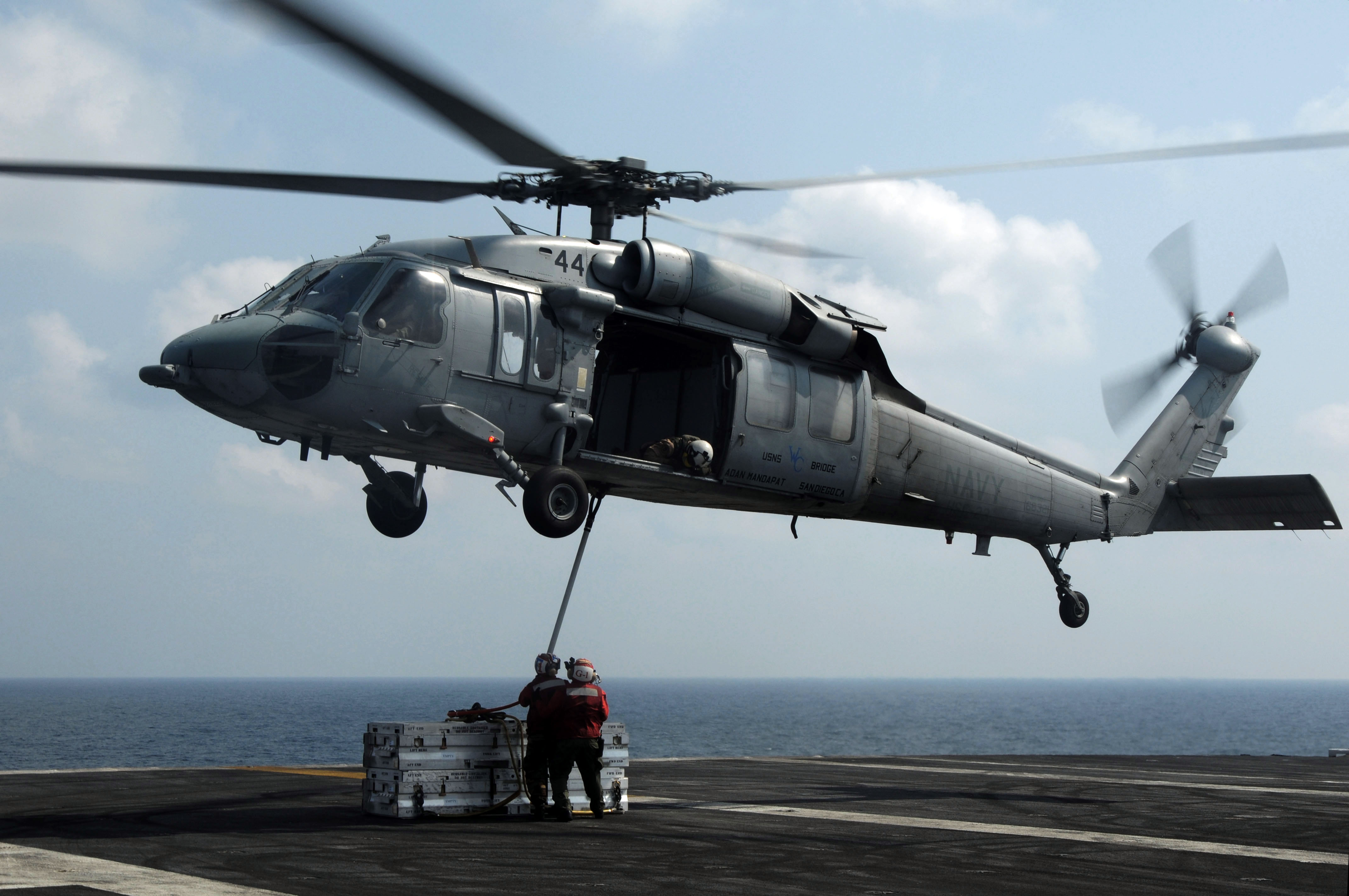 US Navy 091022-N-3038W-939 Aviation Ordnanceman aboard the aircraft carrier USS Nimitz (CVN 68) attach a cargo pendant to a MH-60S Sea Hawk helicopter assigned to the Wildcards of Helicopter Sea Combat Squadron (HSC) 23