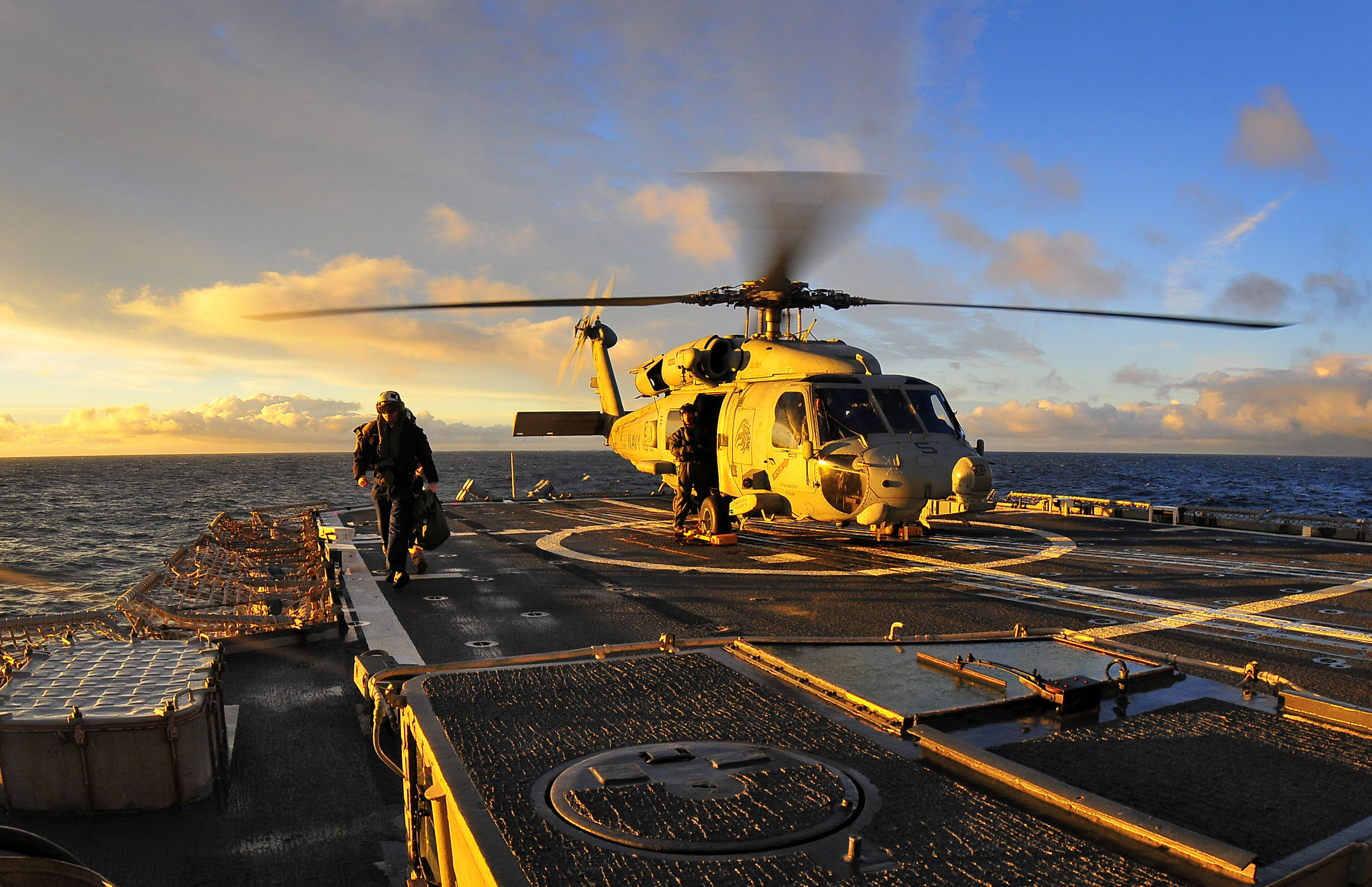 US Navy 100310-N-4774B-008 Aboard the guided-missile cruiser USS Bunker Hill (CG 52), an aircrew member exits an SH-60F Sea Hawk helicopter