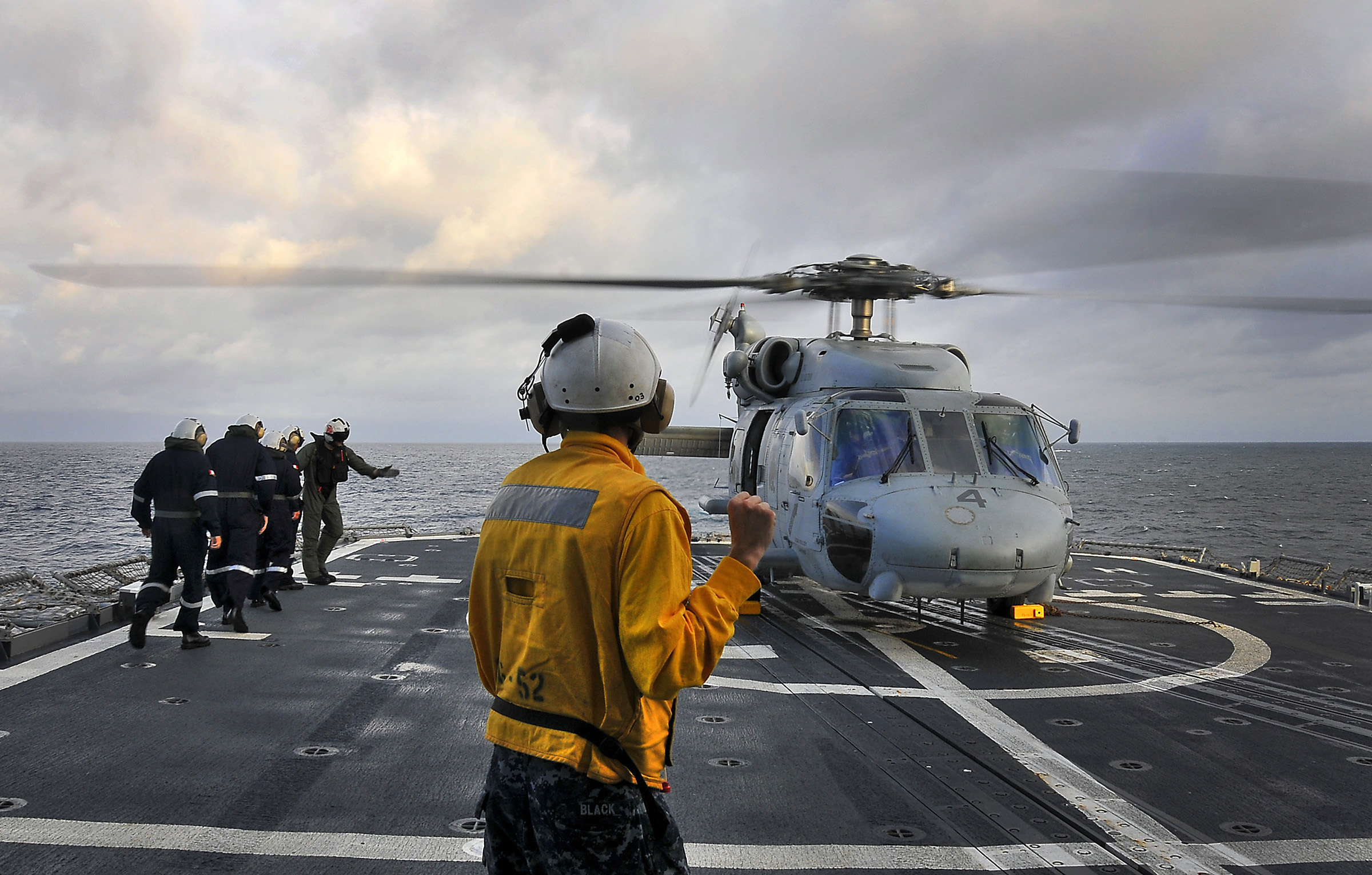 US Navy 100327-N-4774B-157 Boatswain's Mate 3rd Class Alexander Black, from Quinlin, Texas, directs an SH-60F Sea Hawk helicopter assigned to the Red Lions of Helicopter Anti-submarine Squadron (HS) 15