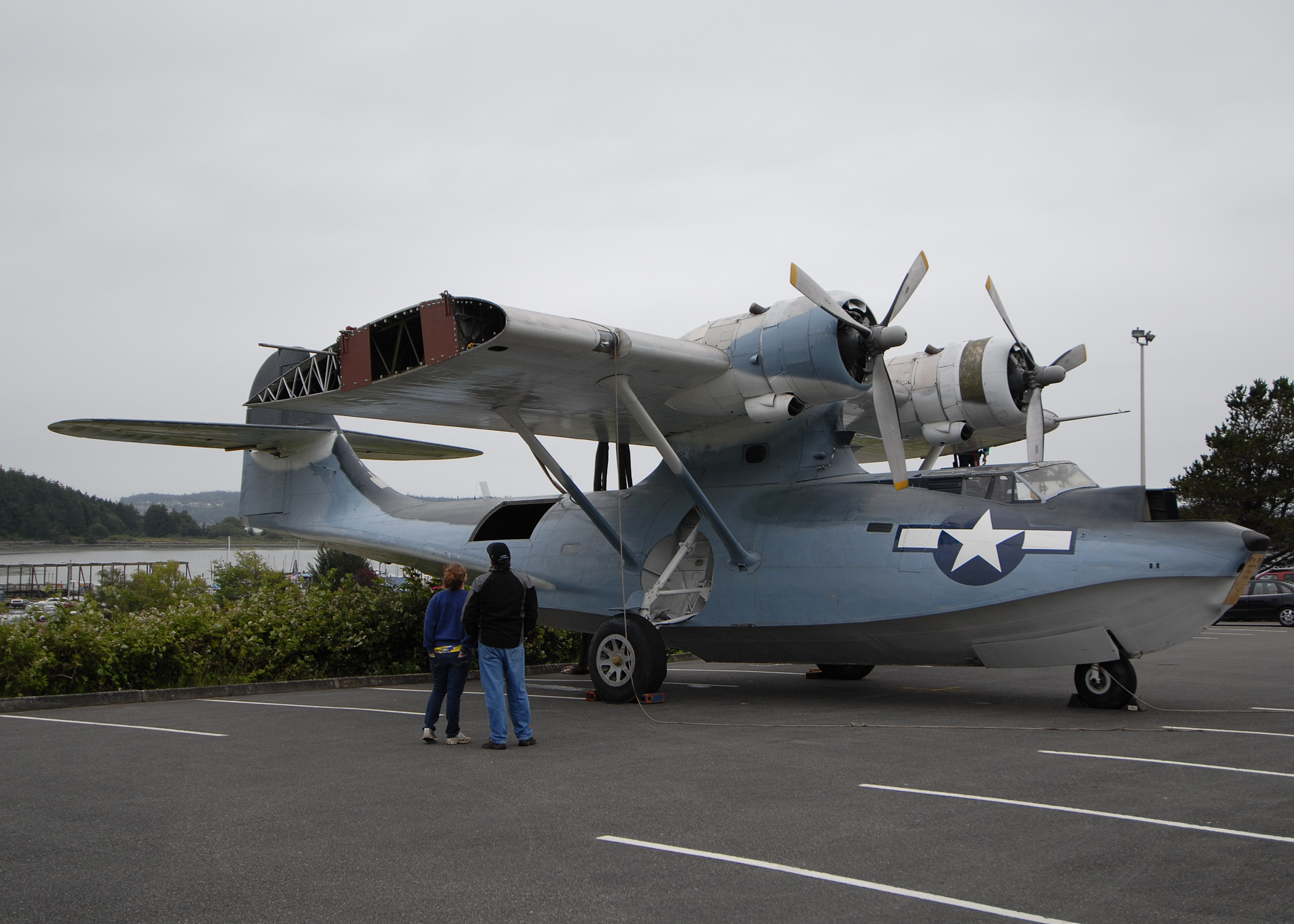 US Navy 100625-N-9520G-004 A father and daughter look at a World War II-era PBY-5A seaplane at Simard Hall at the Naval Air Station Whidbey Island Seaplane Base