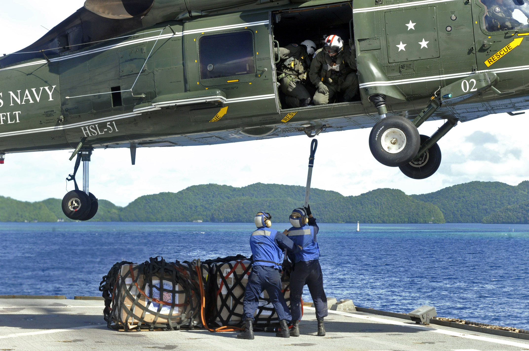 US Navy 100726-N-7478G-212 Sailors attach Project Handclasp materials to an SH-60F Sea Hawk helicopter aboard the U.S. 7th Fleet command ship USS Blue Ridge (LCC 19)