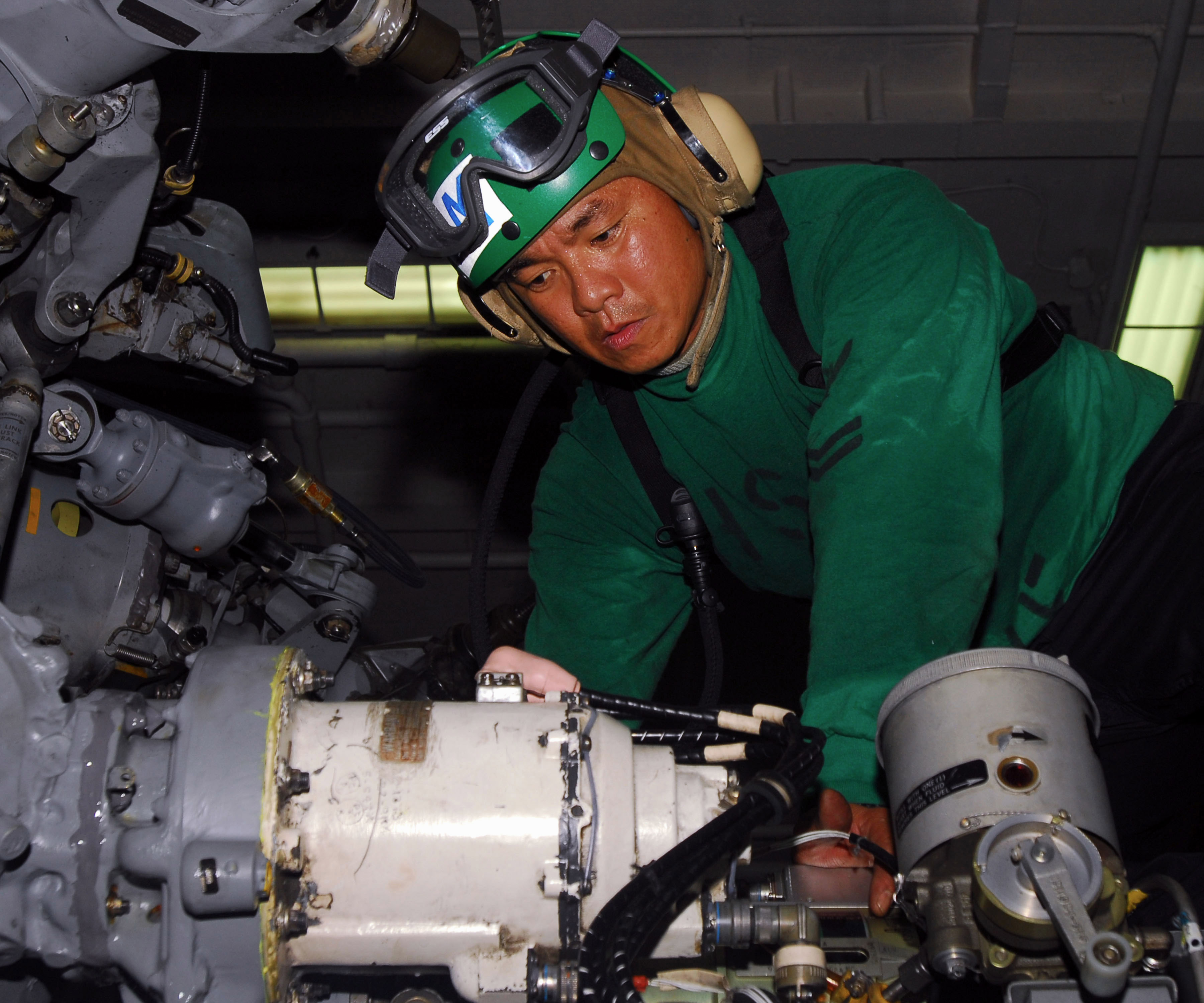 US Navy 100908-N-1276B-189 Aviation Structural Mechanic 2nd Class Joselito C. Centino nstalls a hydraulic pump on an SH-60F Sea Hawk helicopter abo