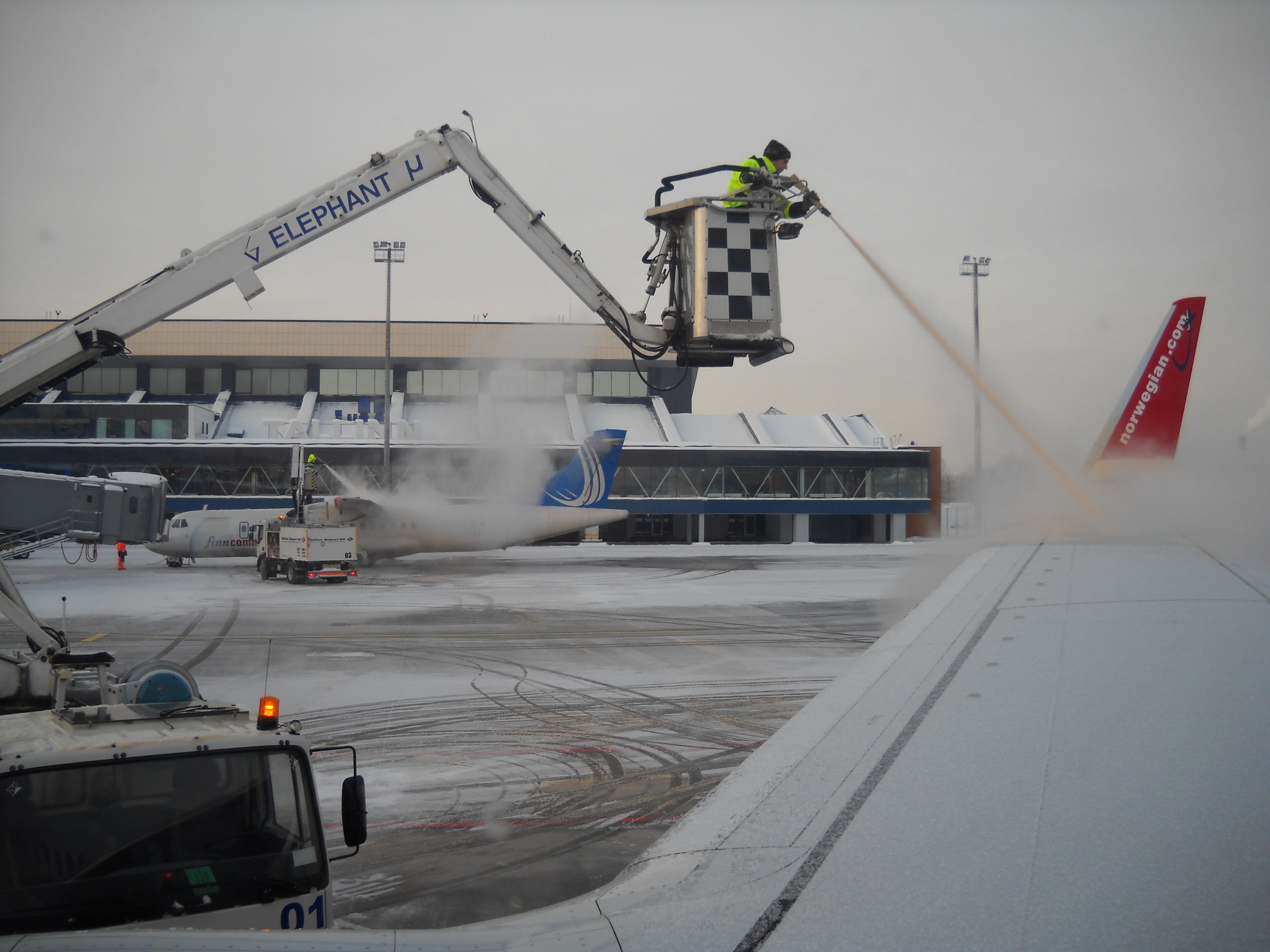 De-icing of Boeing 737-800 from Norwegian Air Shuttle before departure Tallinn Airport