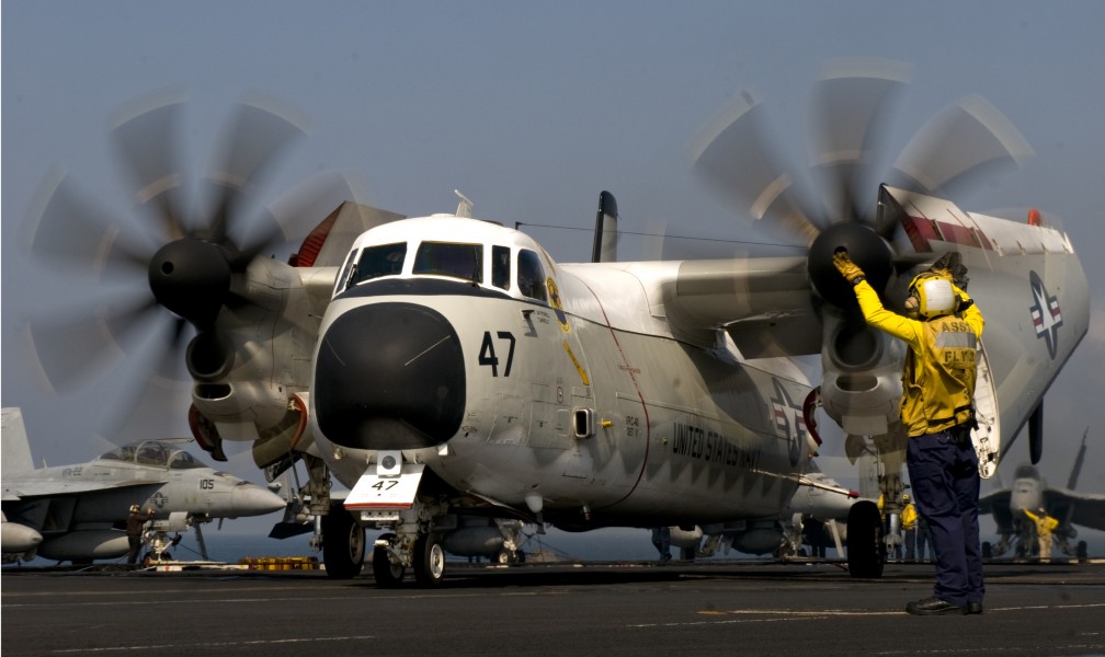Defense.gov News Photo 110303-N-6320L-091 - Petty Officer 2nd Class Mario Billote guides a C-2A Greyhound assigned to Fleet Logistics Support Squadron 40 aboard the aircraft carrier USS Carl