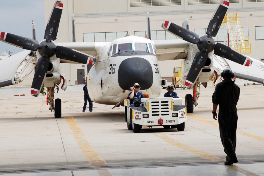 US Navy 060428-N-9689V-025 Fleet Logistics Support Squadron Three Zero (VRC-30) Sailors tow a C2-A Greyhound aircraft into the hangar for maintenance