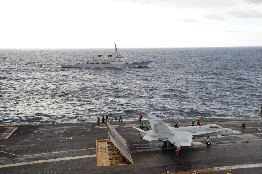 US Navy 101026-N-3418M-123 The aircraft carrier USS George Washington (CVN 73) conducts routine flight operations while the Arleigh Burke-class gui