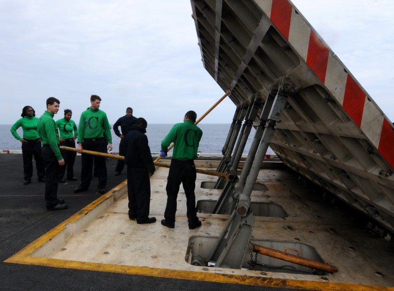 US Navy 110303-N-NB544-131 Sailors practice emergency lowering of a jet blast deflector before graded training aboard the aircraft carrier USS Rona