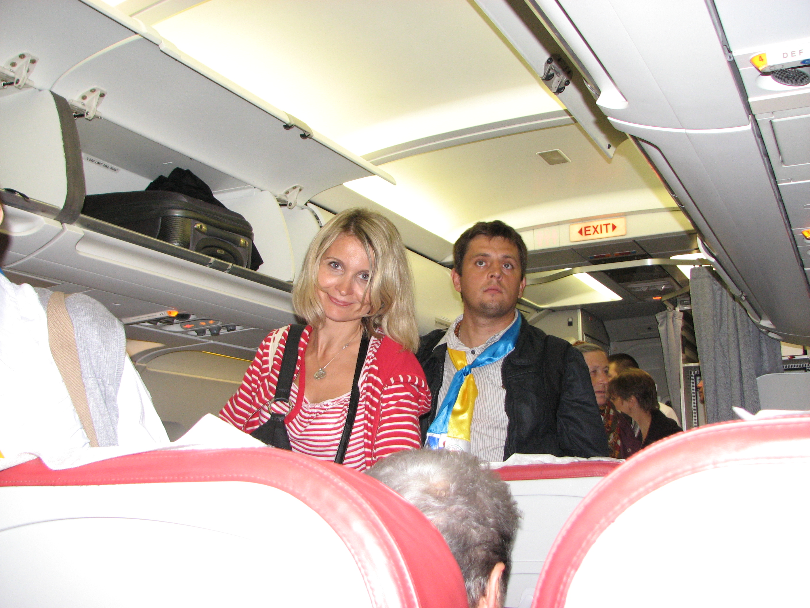 A beautiful Catholic couple - a wife with her husband - during a flight from Tel-Aviv, Israel